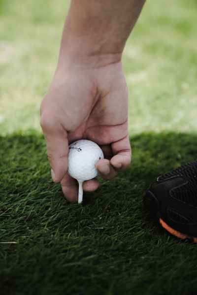 person holding golf ball